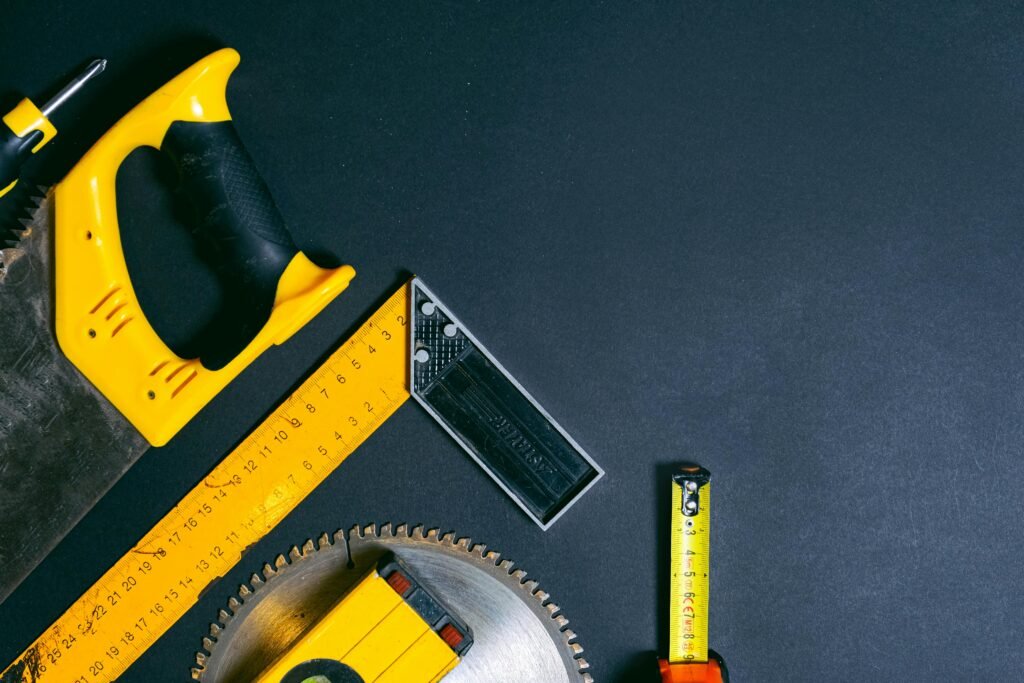 Flat lay of construction tools with copy space on a dark background.